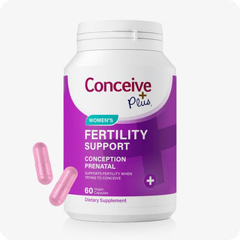 For Conceive Plus Fertility Support Bundle for Him and Her, highlighting women’s fertility support bottle with purple packaging and 60 vegan capsules, designed for conception health; two soft pink capsules are placed nearby, showcasing supplement’s form against white background.